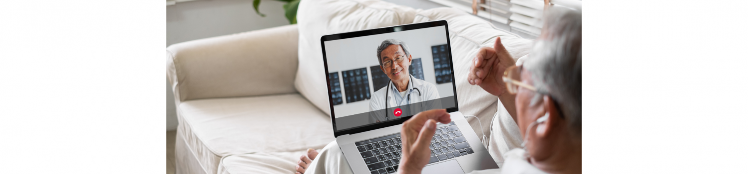 Elderly man having a telemedicine/telehealth video call with his healthcare provider using his laptop at home on his couch