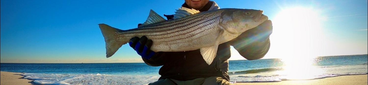 Picture of Steven Adamo, Jr in the winter holding a fish he caught