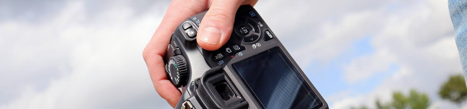 DSLR camera held in hand