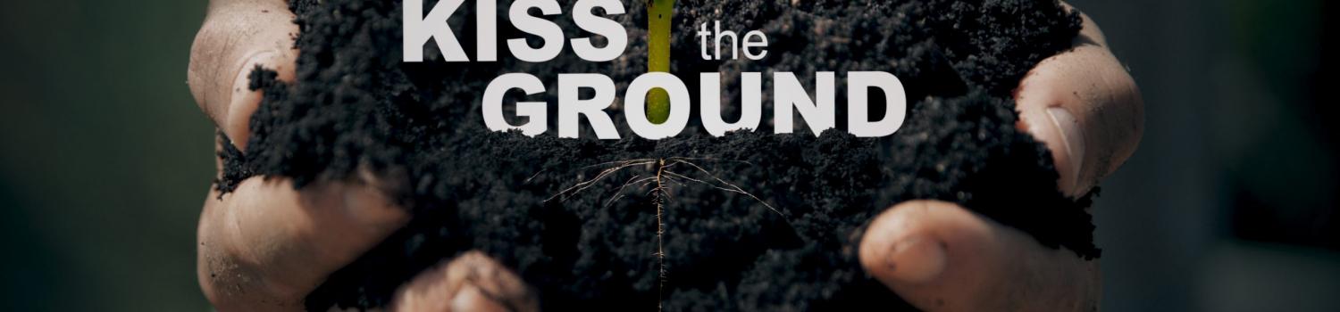 Kiss the ground movie image with hands holding soil and a small seedling