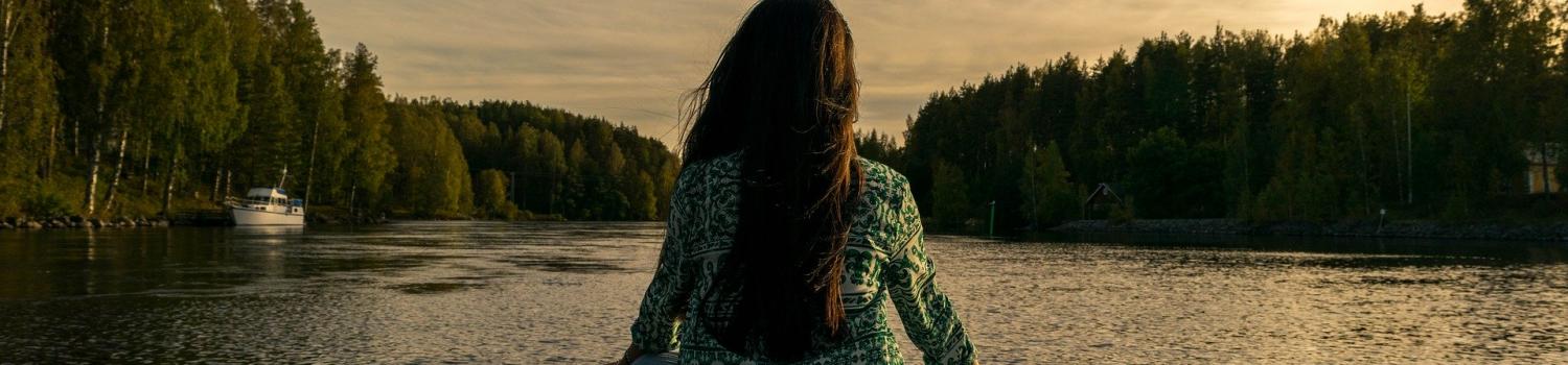 Woman meditating on dock